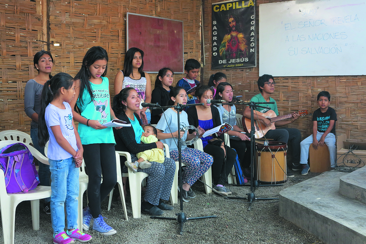 Isabel leads the singing at her chapel - Isabel in her chapel as Eucharistic minister with Fr. John Boles  - Photo: Photos by Eduardo Salas, Director of Communications for the Columban Fathers in Peru.    