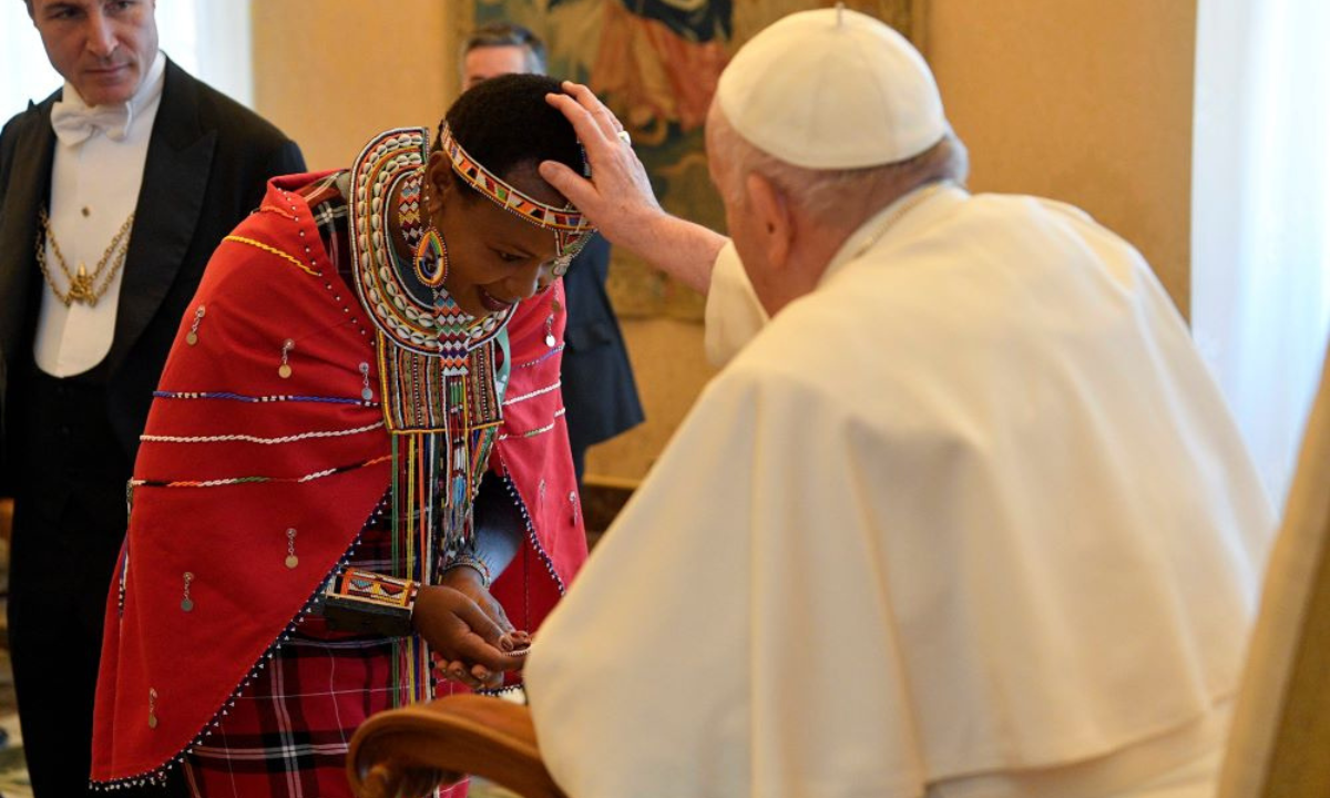 The late Pope Francis blesses an indigenous woman from the African continent in cultural attire (Earthbeat)