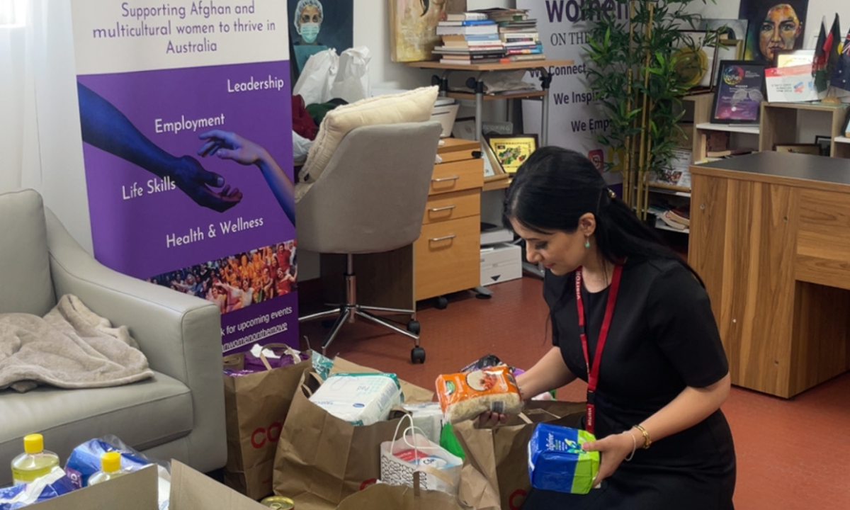 Attendees engaged in packing the hampers while listening to the impactful stories, building bridges of understanding. Photo: Kim Chong
