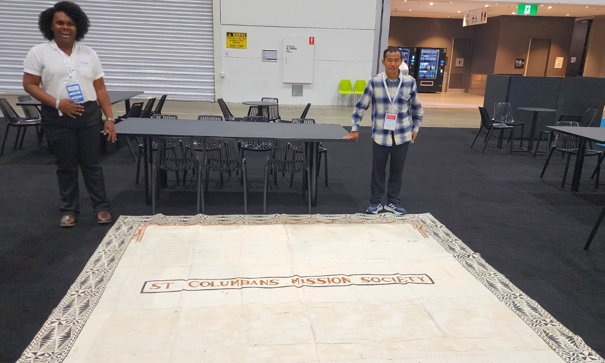 Noa (Fiji) and Fr La-Aung (Myanmar based in Fiji) open to check the masi cloth during set up at the Australian Catholic Youth Festival (ACYF) - Photo: Adi Mariana Waqa