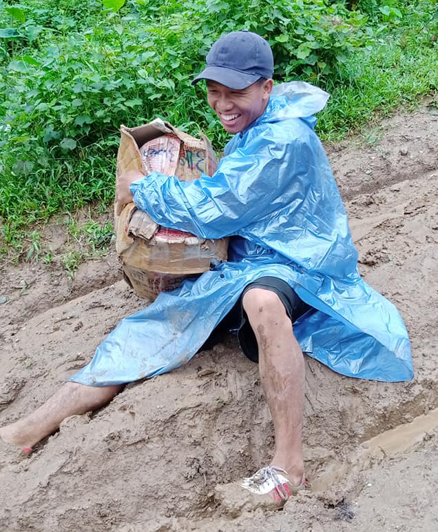 Zawng Dau carrying books and school supplies. Photo: Mr Zawng Dau