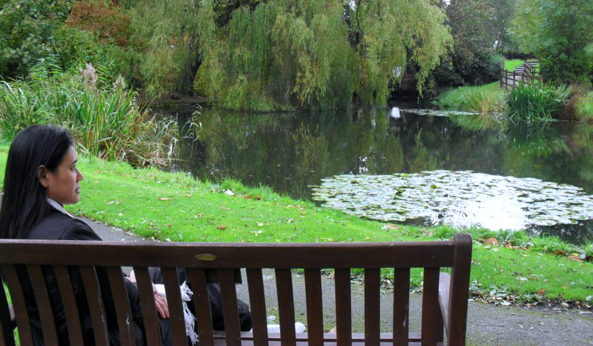femaile reflecting near a lake