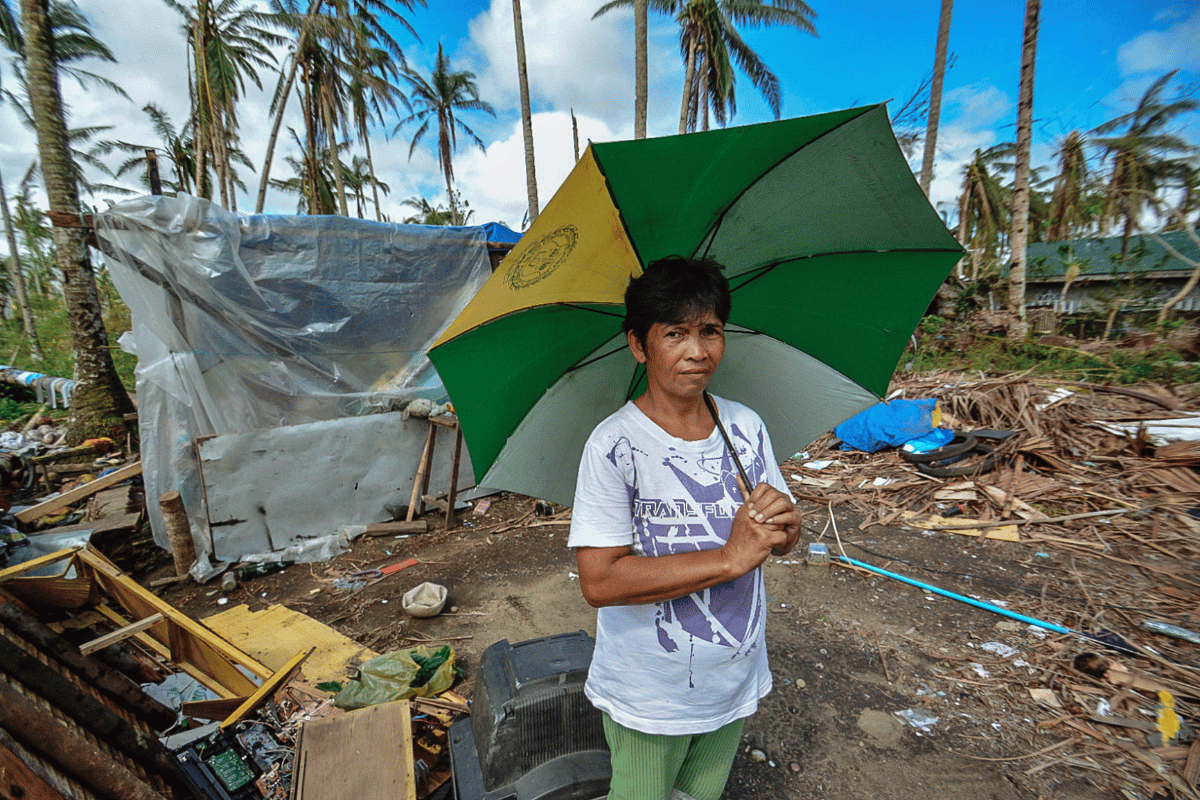 A woman in front of the ruins after Typhoon in Philippines.