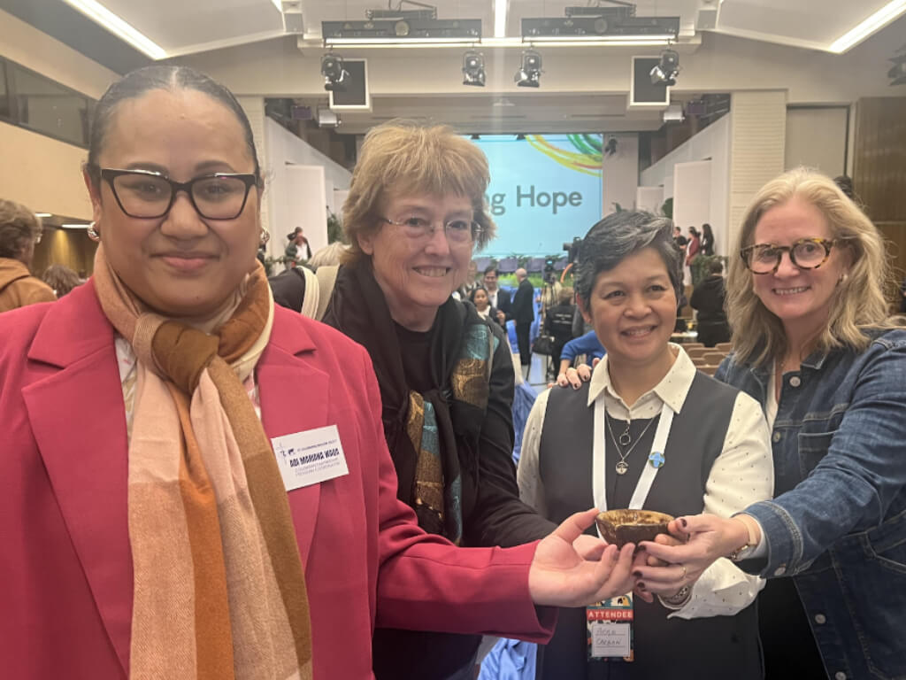 With Ellen Teague, Columban Sister (please insert name), and Amy Echeverria – Holding holy water from the 20,000-year-old iceberg that was blessed by Pope Leo