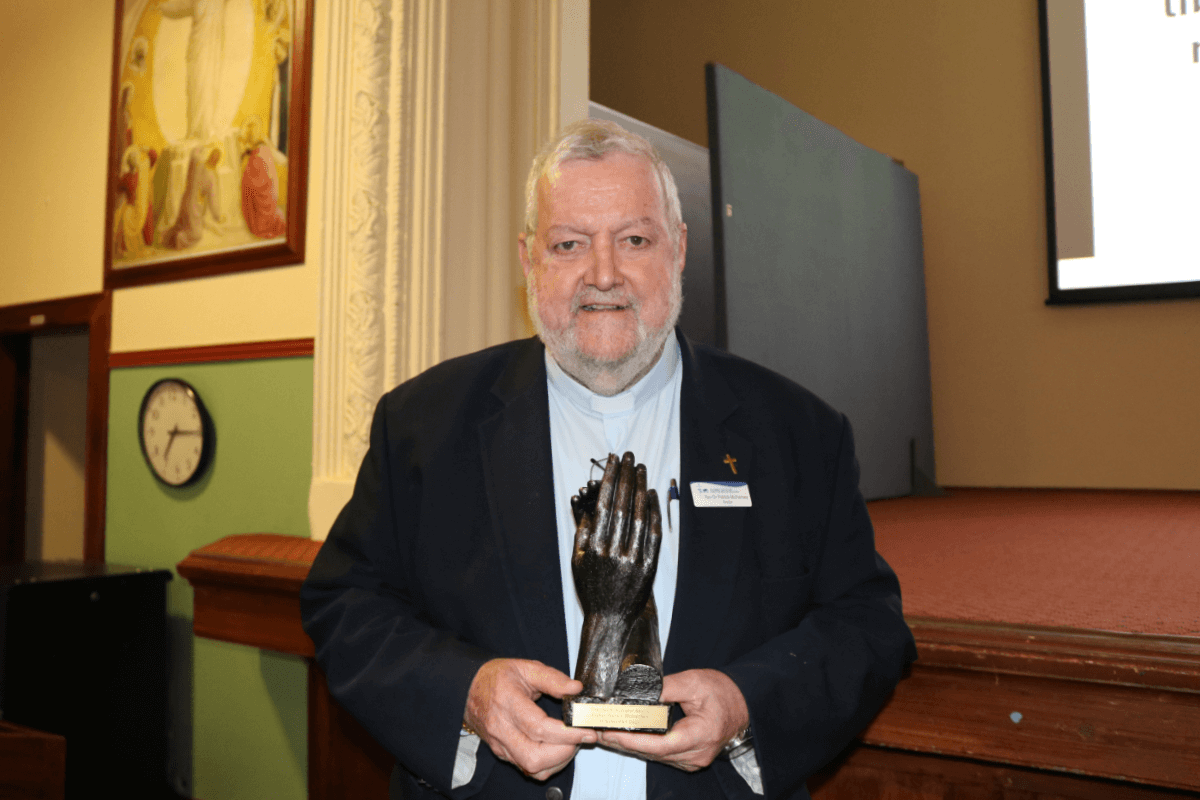 Rev Dr Patrick McInerney with the award. Photo: CCCMR