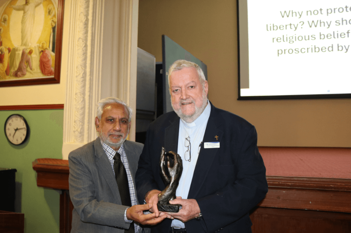 Rev Dr Patrick McInerney receives the inaugural recipient of the Interfaith Dialogue Award from Abbas Raza Alvi, President of the Indian Crescent Society of Australia. Photo: CCCMR