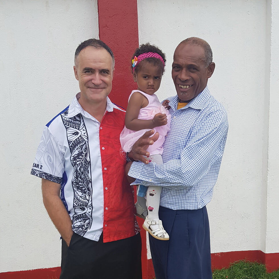 Columban Fr Pat Colgan with a parishioner and his granddaughter after Sunday Mass. Photo: Fr Pat Colgan SSC