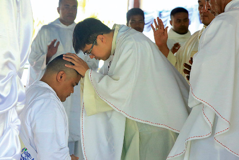 Fr Teakare Betero’s receives a blessing at his ordination in Fiji. Photo: Missionary Society of St Columban