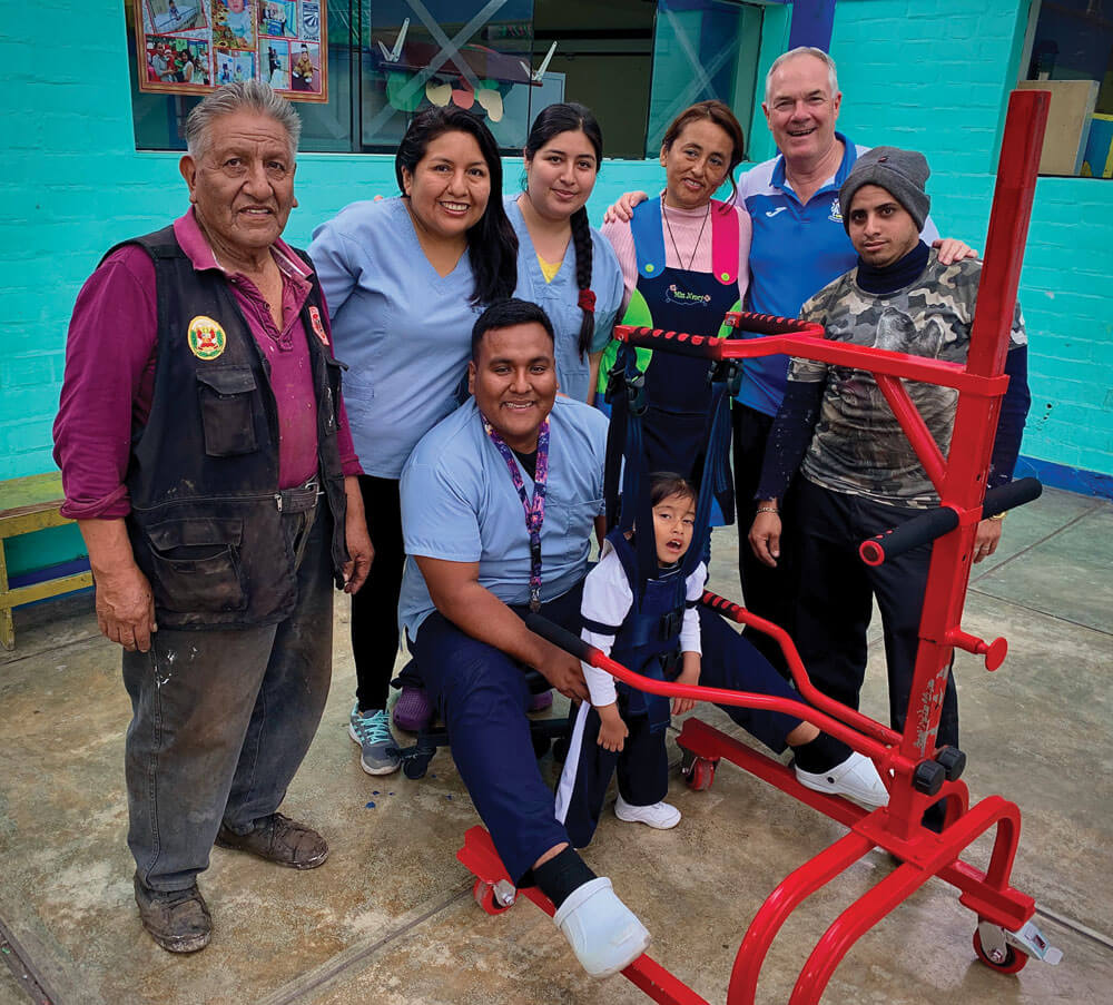 Camila with the team: (left - right) Aurelio (metalworker), Carla, Carlos and Marilyn (physiotherapists), Nancy (Camila's teacher), Fr John Boles and J.B. Martín (metalworker's assistant). Photo: Fr John Boles SSC