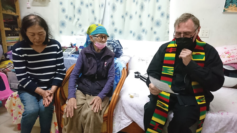 Vesu (left) with MaHong and Columban Fr Larry Barnett (right), celebrating the Sacrament of Anointing the Sick, Taiwan. Photo: Fr Larry Barnett SSC