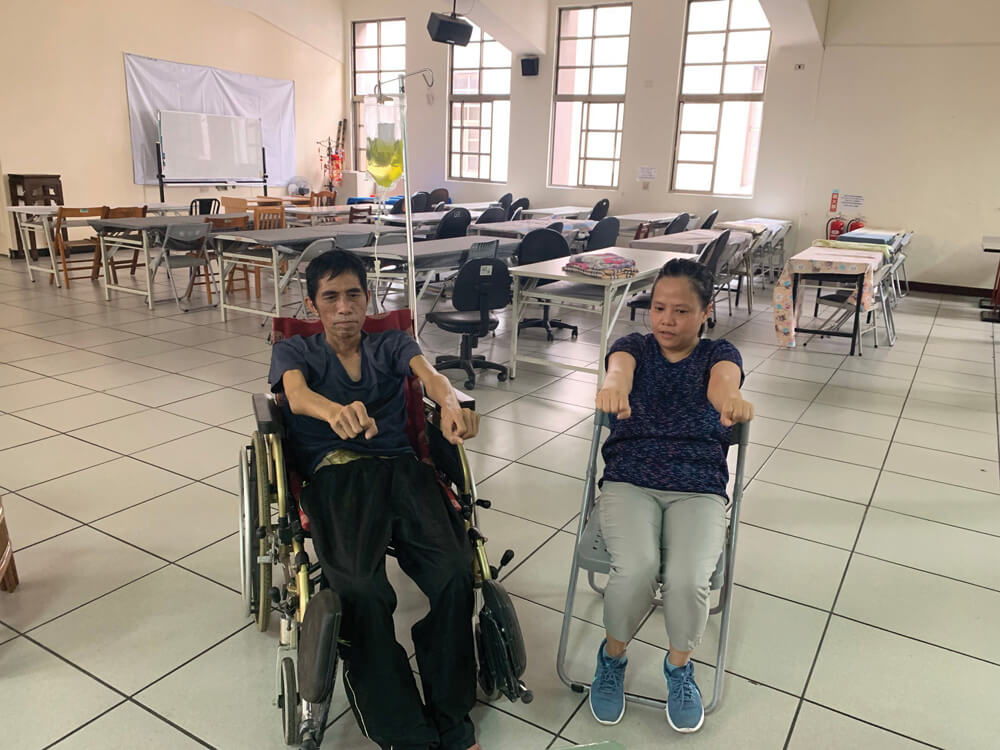 Bailon doing physio with Columban Lay Missionary Joan Yap at the Hope Workers' Centre in Taiwan. Photo: Joan Yap