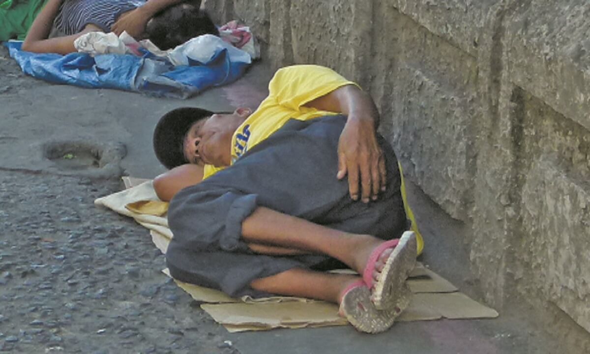 A homeless man sleeps on the streets of Malate in Manila - Photo: St Columbans Mission Society
