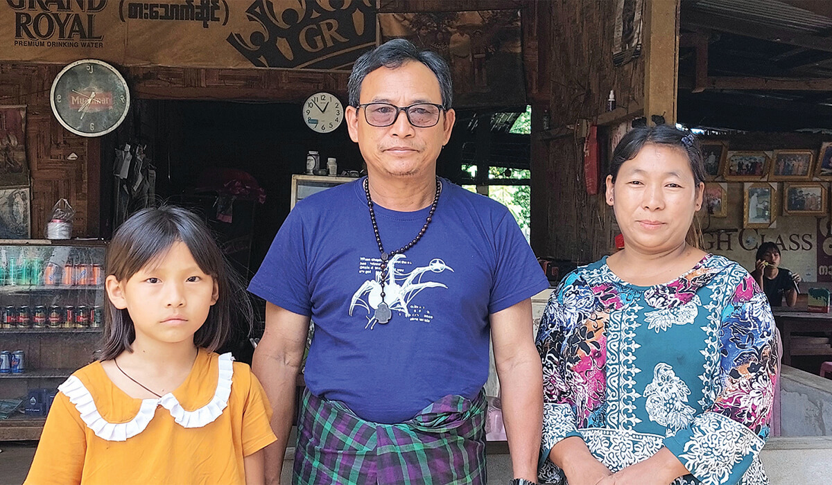 Thomas So Toi Naw (centre) with his wife and a daughter standing outside their restaurant looking down over the rivers - Photo: Fr Frank Hoare