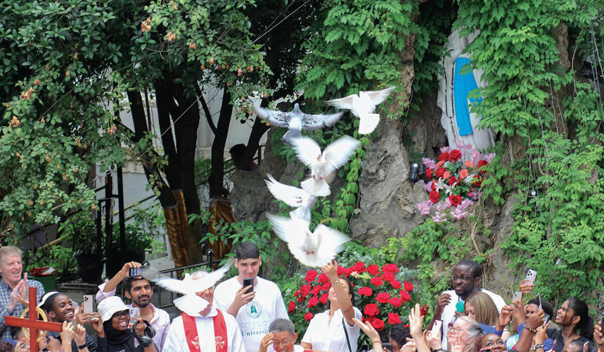 Fr Joseph Peng (centre) gathers with Columbans Fr Kevin O’Neill (far left), Fr Dan Troy (centre left) and the international community to bless the doves before they take flight. - Photo: Fr Kevin O'Neill