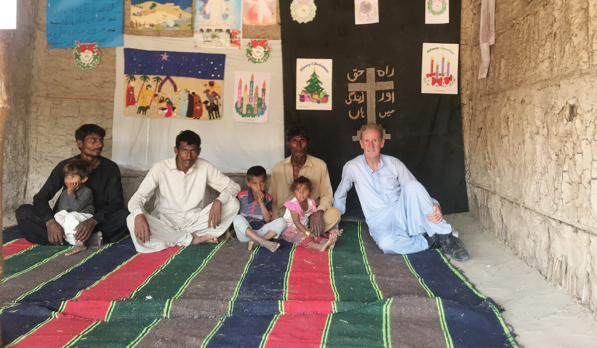 Columban Fr Dan O'Connor (right) with the Parkari Kohli community at Christmas time in Pakistan. Photo: Fr Dan O'Connor SSC