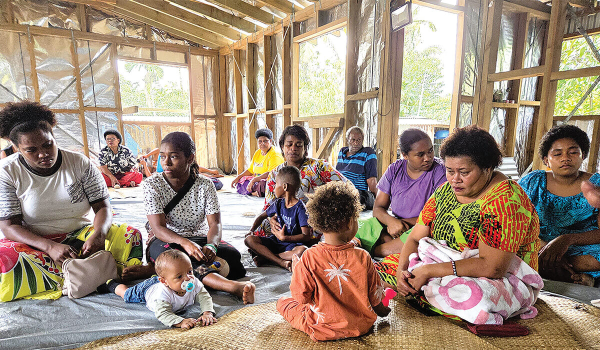 Families of the Nanuku Nine gather for a commemorative Mass, holding photos of their missing loved ones in prayer and hope. Photo: Fr Frank Hoare SSC