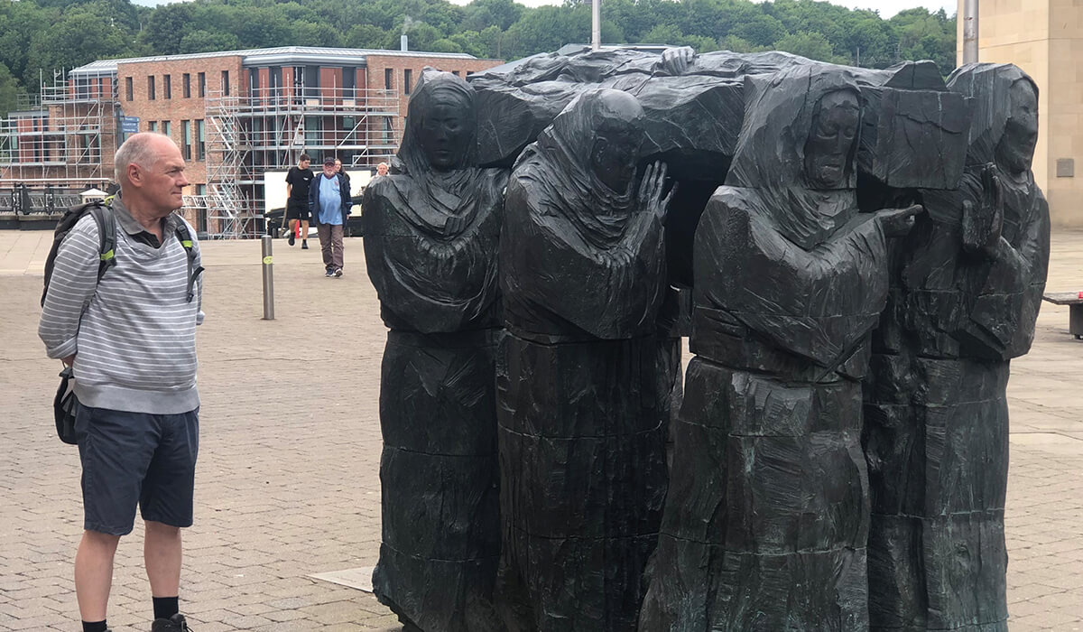 Columban Fr John Boles admiring a modern-day statue in Durham, depicting monks rescuing the uncorrupted body of St Cuthbert from Lindisfarne as Viking raids threatened the island. Photo:Fr Tim Mulroy